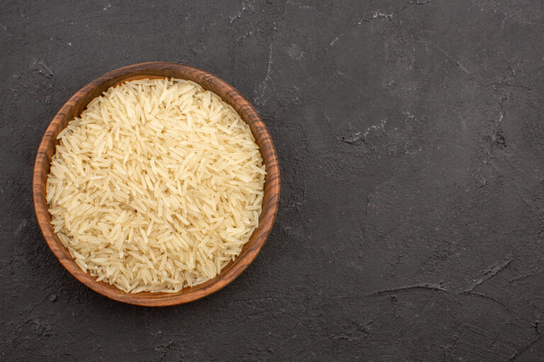 top view raw rice inside brown plate grey surface